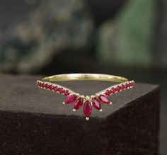 a gold ring with red stones on it