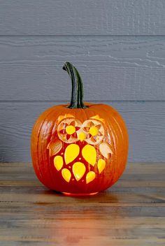 a carved pumpkin with paw prints on it