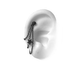 a black and white photo of an ear with chains attached to it's sides