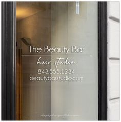 the beauty bar hair studio logo is reflected in the window