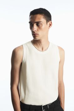 The COS menswear team have been creating elevated closet essentials since the beginning. This knitted tank is testament to that ethos – designed for a relaxed fit, it's been knitted using a racking stitch that gives the organic cotton fabric a beautifully intricate texture. Wear it with a simple chain hanging over the crew neckline.- Round neck- Sleeveless, tubular trims- Organic cotton is grown from non-genetically modified seeds without chemical fertilizers or pesticides100% Organic cotton / Machine washBack length of size M is 24.01" Cos Menswear, Circular Sunglasses, Latest Clothes For Men, Saucony Shadow, Simple Chain, Organic Cotton Yarn, Knit Men, Knitted Vest, Cotton Vest