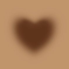 the shadow of a heart on a brown background