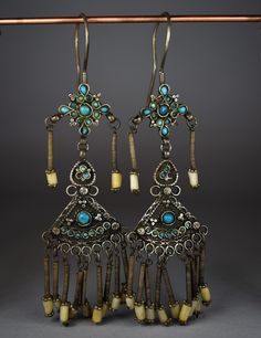 "Antique silver earrings decorated with beautiful antique turquoise beads and small pearls hanging from the sides and from the bottom edge. The earrings measure 4.72 inches (12 cm) in height. Provenience: Uzbekistan. Weight: 14.7 grams each. Back to \"Earrings\" section: https://www.etsy.com/shop/ArteOrientaleBologna?ref=l2-shopheader-name&section_id=18709850 Back to my shop: https://www.etsy.com/shop/ArteOrientaleBologna?ref=hdr_shop_menu" Vintage Turquoise Earrings With Dangling Beads, Traditional Turquoise Dangle Chandelier Earrings, Antique Silver Earrings, Antique Turquoise, Earrings Turquoise, I Love Jewelry, Classic Jewelry, Ethnic Jewelry, Turquoise Earrings