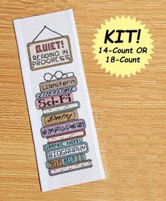 a cross stitch bookmark with the words quiet reading in progress on it and an image of