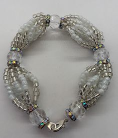 "Handmade Obatala inspired bracelet, made with high quality glass beads. Obatala is the eldest of the orishas in santeria and the king of the religion in orun (heaven). He is also the father of many of the orishas and as such is given great respect and deference by the other orishas in matters of great importance. Colors: White Numbers: 8 Catholic saint: Our Lady of Mercy Item made to order. Will measure approximately 7.5\" unless you request a different size. *All items purchased will be saged White Spiritual Bangle Jewelry, Adjustable Spiritual Crystal Bracelet With Polished Beads, Spiritual Faceted Crystal Bangle Bracelet, Spiritual Healing Glass Bracelets, Handmade White Spiritual Charm Bracelet, Spiritual Bracelets With Faceted Round Beads, Silver Glass Beaded Bracelets With Large Beads, Adjustable Czech Glass Jewelry Bracelet, Silver Glass Beaded Bracelets With Spacer Beads