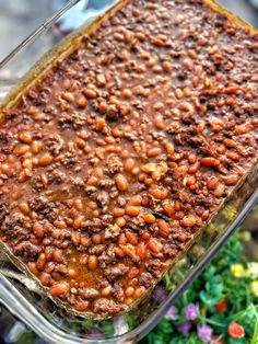 a casserole dish filled with baked beans and ground beef is ready to be eaten