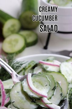 cucumber salad in a white bowl with a spoon on the side and text overlay that reads creamy cucumber salad