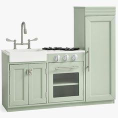 a toy kitchen with green cabinets and white sink