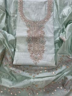 an embroidered shirt with beading on it