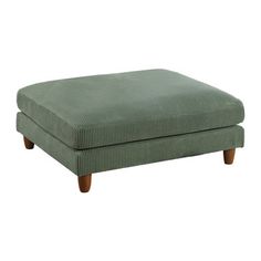 a green ottoman with wooden legs