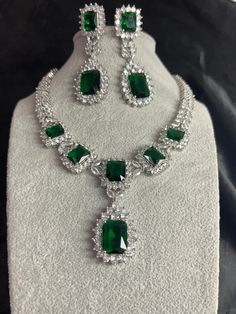 Gorgeous fine quality replica diamond and emerald green studded necklace with a white  rhodium plating and matching Earrings Item contains: Necklace and earrings AAA-quality cubic zirconia was used. Highest quality and craftsmanship Necklace Fitting is adjustable Earrings Closure: Pushback Necklace Closure: chain with Hook Green Sparkling Stones Jewelry Sets For Party, Green Jewels Jewelry For Formal Occasions, Elegant Green Crystal Jewelry Sets, Formal Green Jewelry With Jewels, Formal Green Jeweled Jewelry, Silver Emerald Jewelry Sets For Gift, Green Crystal Jewelry Sets With Sparkling Stones, May Birthstone Party Jewelry, Silver Emerald Jewelry Sets For Anniversary