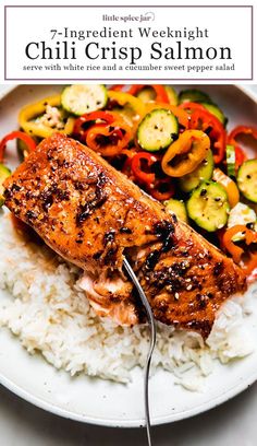 a white plate topped with salmon and rice