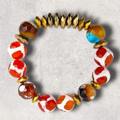 Materials used: Tibetan and fire agate beads and pale and antique gold hematite beads. Length: 7.5" Artisan Gold Beaded Bracelets With Natural Stones, Multicolor Agate Jewelry With Faceted Beads, Multicolor Agate Beaded Bracelets With Colorful Beads, Multicolor Carnelian Jewelry With Polished Beads, Amber Agate Hand-strung Beaded Bracelets, Adjustable Multicolor Agate Jewelry, Agate Faceted Round Beaded Bracelets, Multicolor Carnelian Beaded Jewelry, Adjustable Amber Agate Beaded Bracelet