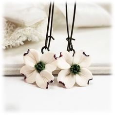 This listing is for 1 pair of hand sculpted white Dogwood dangle earrings or drop earrings. Choose from assorted kidney or leverback earwires or titanium (hypoallergenic) short hooks.  -Original hand sculpted polymer clay flowers -Durable, water-resistant -No molds, no paint, no glue -Assorted earwires to choose from -Titanium (hypoallergenic) option available -Flower size : 1.5cm -Lightweight earrings View matching collection at:  https://www.etsy.com/shop/strandedtreasures/search?search_query= Nature-inspired Nickel Free White Earrings, White Hypoallergenic Nature-inspired Earrings, Nature-inspired Hypoallergenic White Earrings, Hypoallergenic White Nature-inspired Earrings, White Flower Earrings, Dogwood Flower, White Flower Earring, Clay Color, Dogwood Flowers