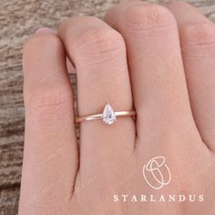 a woman's hand with a diamond ring on top of her finger and the words starlandus written below it