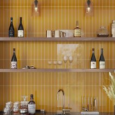 bottles and glasses on shelves in a kitchen