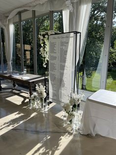 the ceremony room is decorated with white flowers