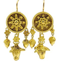 Crafted with intricate artistry and symbolic significance, these gold dangle earrings evoke the mystical allure of a dream catcher motif. Cast in luxurious 22 karat yellow gold, these earrings exude an aura of opulence and timeless elegance. There are three dangles off each earring; the center has a carved cow head and delicately sculpted acorns flank each side. The hooks of the earrings, crafted from durable 18 karat gold, ensure both stability and longevity, balancing the softness and malleabi Luxury Carved Yellow Gold Earrings, Symbolic Yellow Gold Pierced Earrings, Symbolic Yellow Gold Round Earrings, Pendant Earrings With Intricate Design In Yellow Gold, Luxury Earrings For Festivals, Traditional Yellow Gold Pendant Earrings, Luxury Gold Pierced Chandelier Earrings, Luxury Yellow Gold Earrings For Ceremonial Occasions, Yellow Gold Pendant Earrings With Intricate Design