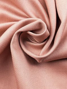 a close up view of the fabric on a plain pink shirting material that is very soft