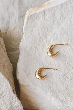 Cast stud hoop earrings with an organic textured surface. A simple statement earring that looks great layered with other styles.Please note: May be heavy for sensitive ears Recycled brass with sterling silver studs coated in a thick layer of high grade 14k gold. Handmade in the USA using sustainable earth-friendly materials. CARE: Most metals will naturally patina over time, however, there are measures you can take to prolong the life of your jewelry. We recommend removing all jewelry prior to s Minimal Jewellery, Statement Earring, Minimal Jewelry, Sell Gold, Jewelry Cleaner, Earth Friendly, Sterling Silver Studs, Sensitive Ears, Star Necklace