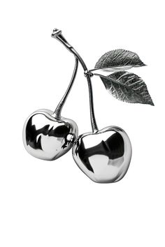 two metal cherries with leaves on them