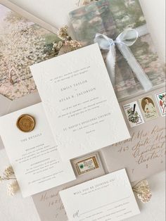 the wedding stationery is laid out on top of each other, including an envelope