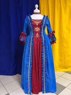 The dress is blue gabardin with a burgundy jacuard. The bustier is decoreted with a ruffle and golden ribbon. The closure in the back is burgundy lacing with grommets. The main decorative piece of the dress are the large ruffles, patterned on the edges of the top and the center bottom of the skirt. The sleeves are trimmed with openwork lace. In order to be able to fix the skirts in a desired position, the dress comes with soft crinoline. The look is completed with a lace neckband. We have this d Targaryen Fashion, Medieval Dresses, Rococo Dress, Golden Ribbon, Make A Dress, 18th Century Dress, Custom Made Suits, Century Dress, Princess Core