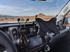 the interior of a vehicle with steering wheel and dash stick holders on it's dashboard