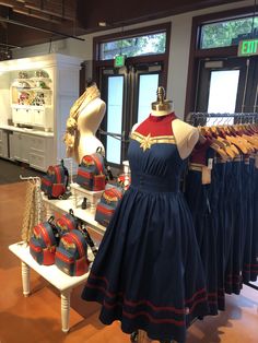 there are many dresses on display in the store, and one is wearing a captain america costume