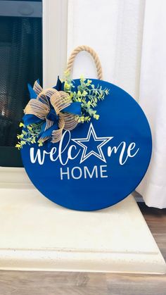 a blue welcome home sign sitting on top of a white counter next to a window