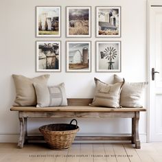 a bench with pillows and pictures on the wall above it, along with a wicker basket