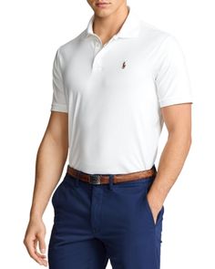 Ralph Lauren's Pima Soft-Touch Polo Shirt has been specially treated to give it a lustrous, refined look and an ultra-soft feel. What's more, the collar and armbands are constructed to retain their fit even after multiple washes. Classic Stretch Tops For Business Casual, Classic Fitted Polo Shirt For Workwear, Fitted Long Sleeve Polo Shirt For Formal Occasions, Fitted Polo Collar Shirt, Fitted Solid Shirt With Polo Collar, Elegant Fitted Polo Shirt For Spring, Classic Fitted Top For Business Casual, White Fitted Top For Business Casual, White Stretch Tops For Business Casual