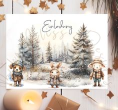 a christmas card with two bears in the snow and a candle next to it on a table