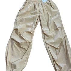 Elevate Your Casual Style With These Trendy Khaki Parachute Joggers From Better / Together. Made For Women, Feature A Comfortable Jogger Style With A Unique Design. The Beige Color And Together Brand Add A Touch Of Sophistication, Making Them Perfect For Both Casual And Dressy Occasions. Ideal For The Fashion-Forward Woman Who Loves To Make A Statement, These Joggers Are A Must-Have Addition To Your Wardrobe. Beige Parachute Pants With Pockets For Summer, Baggy Khaki Parachute Pants For Summer, Summer Parachute Pants With Elastic Waistband And Tapered Leg, Spring Harem Pants With Cargo Pockets, Spring Solid Color Harem Pants With Cargo Pockets, Trendy Solid Ankle-length Parachute Pants, Solid Color Summer Cargo Pants For Loungewear, Summer Utility Pants In Solid Color, Solid Color Utility Pants For Summer