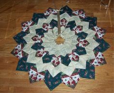 a quilted christmas ornament on a wooden floor