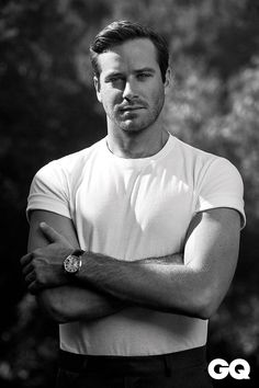 a black and white photo of a man with his arms crossed