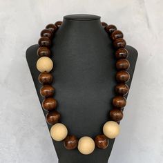 Modern Wood Bead Necklace, Unisex Wooden Necklace, Chunky Wood Necklace UNISEX Wood Necklace, Two Tone Wood Necklace, Mens Wood Necklace This unique necklace was hand beaded using a mix of large 25mm round dark brown wooden beads and four extra large 30mm round natural pine beads in a fresh, modern design. The necklace measures approximately 27 inches long and is securely fastened with a silver lobster clasp. Perfect for any gender. Length can be adjusted if needed - just ask! Check out more fab Everyday Brown Jewelry With Large Beads, Brown Wooden Beads Round Jewelry, Brown Wooden Beads Jewelry, Brown Round Wooden Beads Jewelry, Brown Round Beaded Necklace With Large Beads, Brown Beaded Necklace With Large Round Beads, Wooden Round Bead Necklaces For Gifts, Wooden Round Bead Necklaces As Gift, Wooden Round Beads Necklace As Gift