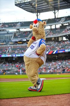 a mascot is standing on top of a baseball field