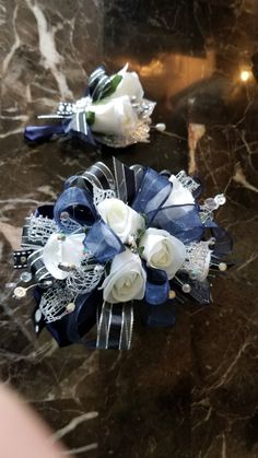 two bridal bouquets sitting on top of a marble table