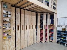 several wooden doors in a room with shelves and tools on the wall next to each other