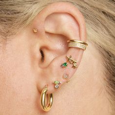 a woman with ear piercings on her ears and behind the ear is a star