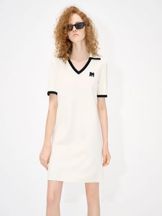 MO&Co. Women's Polo Collar Contrast Dress Made from a blend of 67.5% viscose and 32.5% polyamide for a unique finish, it offers a V-neck collar with contrasting trim details, and a signature M logo patch for added flair. Perfect for any special occasion, this refined dress will be a timeless addition to your wardrobe. Features : - V-neck with collar design- Contrasting trim details- Embroidered M logo patch front Code: MBC2DRS023The back length of size S is 86cmMATERIALS & CARE Material: 67.5% V Spring Mini Dresses With Contrast Trim, Classic V-neck Mini Dress For Daywear, White Chic Dress With Contrast Trim, Fitted Mini Dress With Contrast Trim For Spring, Chic Dresses With Contrast Collar, Fitted Summer Dress With Contrast Trim, Viscose V-neck Mini Dress For Workwear, Classic Summer Mini Dress With V-neck, Knee-length Viscose V-neck Dress