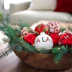 a wooden bowl filled with red and white ornaments