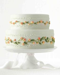 a three tiered cake with flowers on it