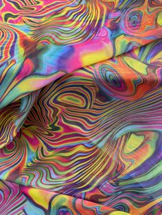 an abstract painting with multicolored lines and swirls on the fabric, as well as