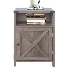 an end table with books and a candle on top