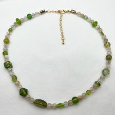 Olive Green Beaded Choker Necklace Earth Tone Beaded Choker Random Beaded Choker Gemstone Glass Beaded Necklace Short Multi Beaded Necklace Summer Beaded Necklace Recycled Beaded Necklace Mid Century Style Necklace Short Beaded Necklace Gift for Her Gift for Mom Gift for Friend Mid Century design Olive Green and Brown Glass Glass Gemstone Beaded Choker Necklace with Lobster Claw Closure and 3 inch Extender Chain.  DETAILS OF THE NECKLACE:   *Random Beads sizes 4mm to 8mm: -Various Shapes and Sizes Olive Green Glass Beads recycled from a vintage necklace   -Natural Moon Stone Crystal Quartz Beads  -Frosted Beige Glass Beads *Closure:  Lobster Claw with 3 inch/7.62 centimetre Extender Chain *Necklace Measurement: 15.75  inches/ 40 centimetres  with extender chain 18.75 inches/ 47.62 centimet Summer Beaded Necklace, Short Beaded Necklace, Vert Olive, Summer Necklace, Beaded Choker Necklace, Glass Bead Necklace, Jewelry Companies, Beaded Choker, Mid Century Style