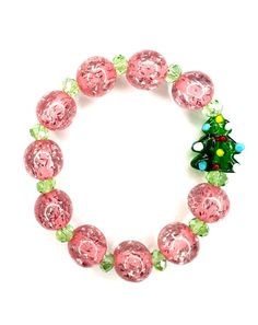 Pink and green are the bold colors this Christmas season. A glass tradition green Christmas tree with multicolored ornaments is surrounded by 12mm glass clear pink tinsel filled ball beads. Bold, feminine, and traditional. The perfect accessory for all those holiday parties!  Bracelets are available in a variety of lengths.  Pick your custom length from the drop down menu below.  Please be aware that beading may slightly differ from what is pictured as to accommodate selected sizing.  All our br Fairy Tale Jewelry, Snowflake Bracelet, Candy Bracelet, Stocking Stuffers For Her, Stretchy Beaded Bracelet, Handmade Yarn, Winter Jewelry, Fashion Beads, Jewelry Words