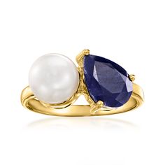 an 18k yellow gold ring with two pear shaped sapphires and a white pearl