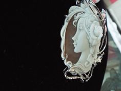 "This is a beautiful modern master hand carved sardonyx cameo by the artist, Carla. This is a very complex and intriguing piece and the design makes it an absolutely amazing piece of work. All the detail is exceptionally done to perfection! The right cameo is cameo is 48 mm mm (1.89\") and it is set into Italian silver with a 6 mm enhancer bail and a pin attachment. It comes packed in a black velvet box and certificate of authenticity for gift giving. Welcome to CASCO Cameos, LLC. CASCO Cameos i Luxury Cameo Pendant Jewelry, Elegant Carved Oval Jewelry, Elegant Oval Carved Jewelry, Collectible Art Nouveau Carved Jewelry, Luxury Cameo Medallion Jewelry, Exquisite Cameo Jewelry For Formal Occasions, Luxury Intaglio Pendant Jewelry, Luxury Carved Jewelry For Gift, Art Nouveau Oval Cameo Jewelry